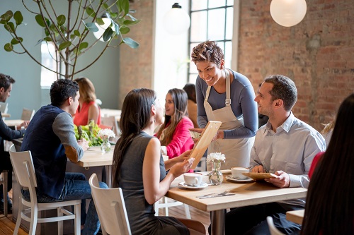 Female-restaurant-server-providing-service-to-customers